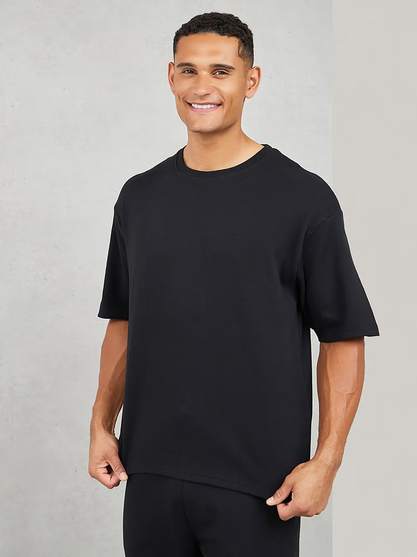 Styli Men Black Varsity Back Print T-Shirt & Open Hem Trackpant Interlock Co-ord Set