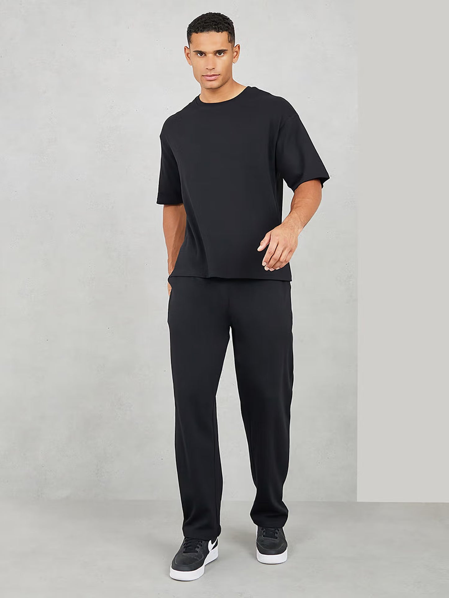 Styli Men Black Varsity Back Print T-Shirt & Open Hem Trackpant Interlock Co-ord Set