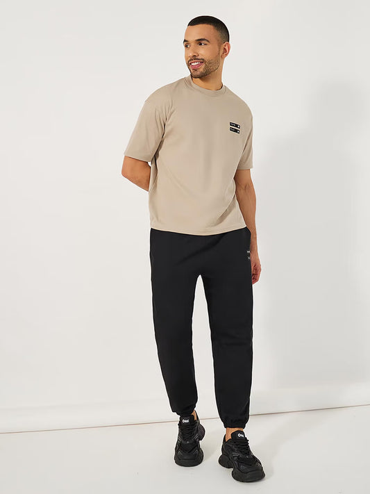 Styli Men Beige Minimal Graphic Mock Neck Oversized Co-ord Set